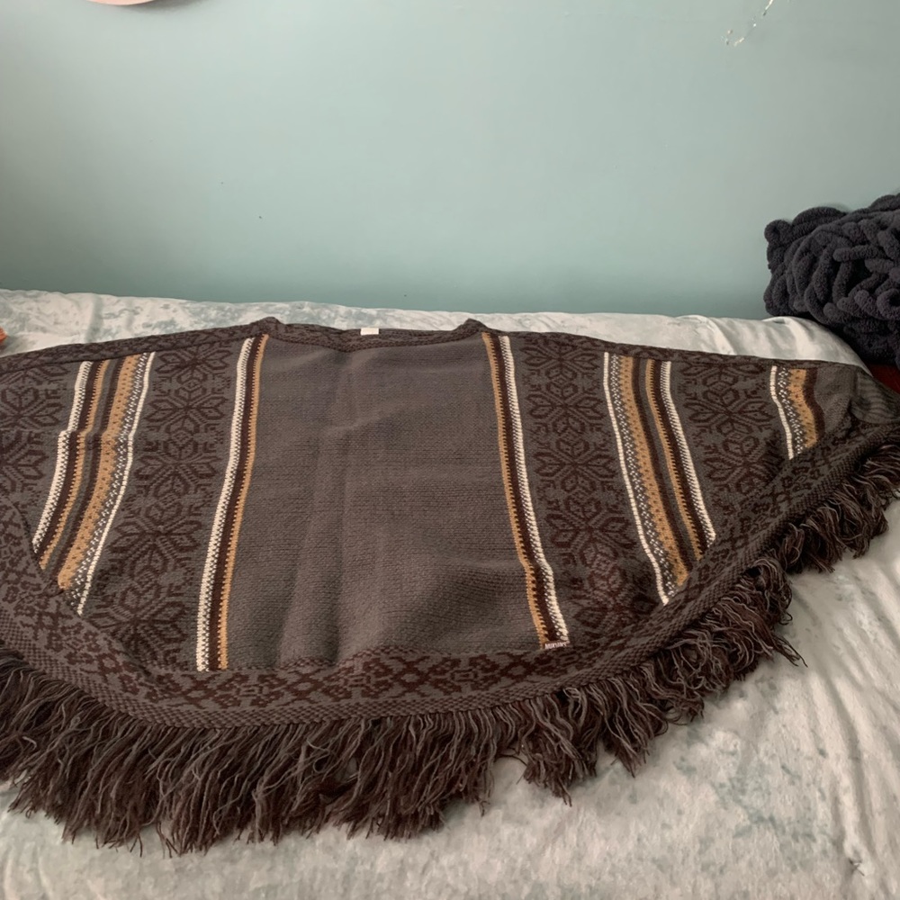 Poncho one size fits all.  Grey with tan and brown accents.  MukLuks brand